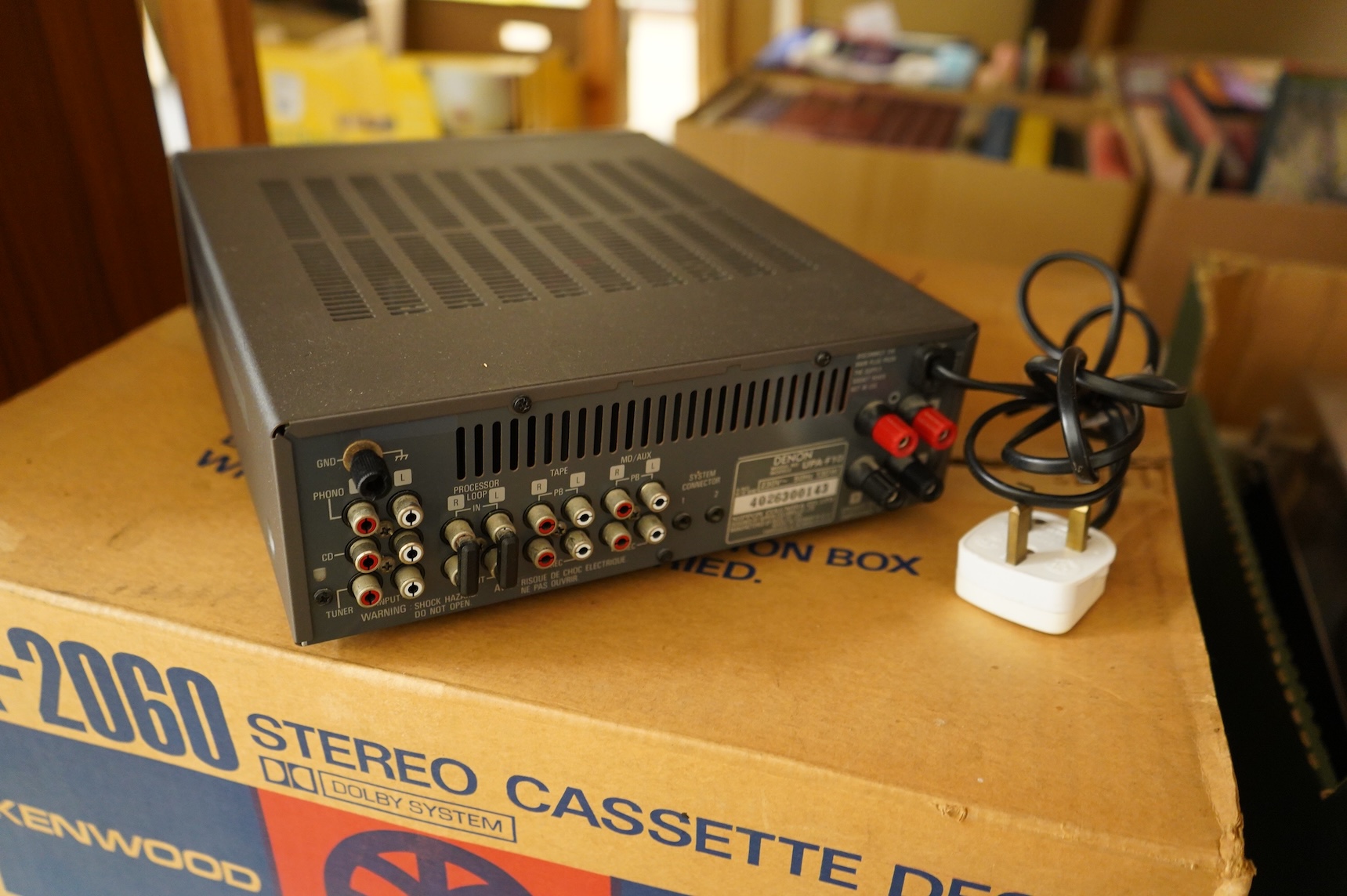 A collection of stereo equipment, including a Project P1 turntable record player, a Denon UPA-F10 integrated stereo amplifier with remote control, a boxed Kenwood KX-260 cassette tape player and a pair of Monitor Audio s